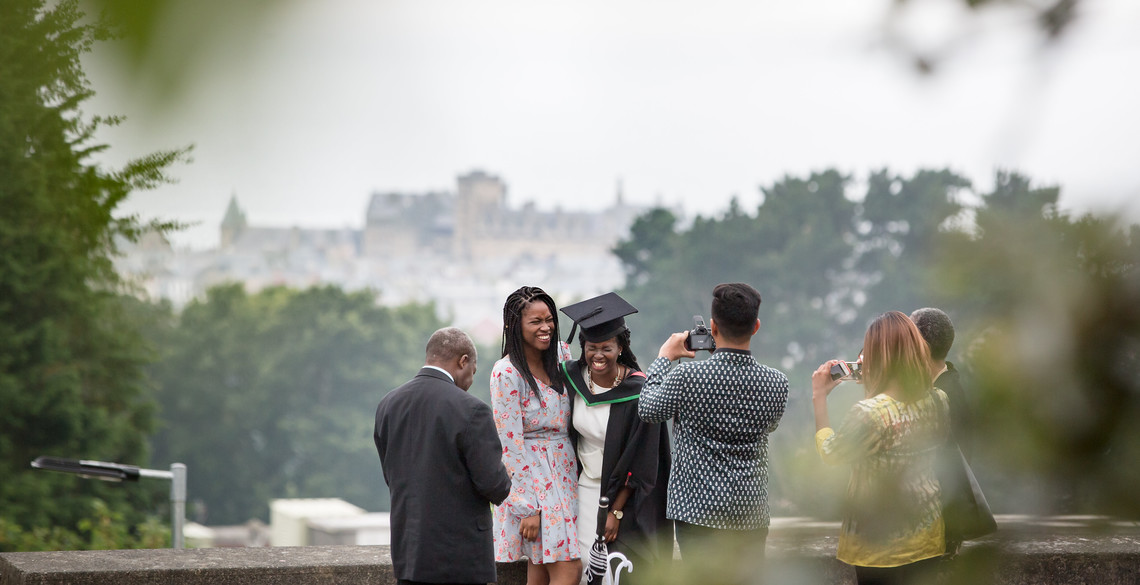 a picture being taken of a family during the 2018 Graduation ceremonies. 